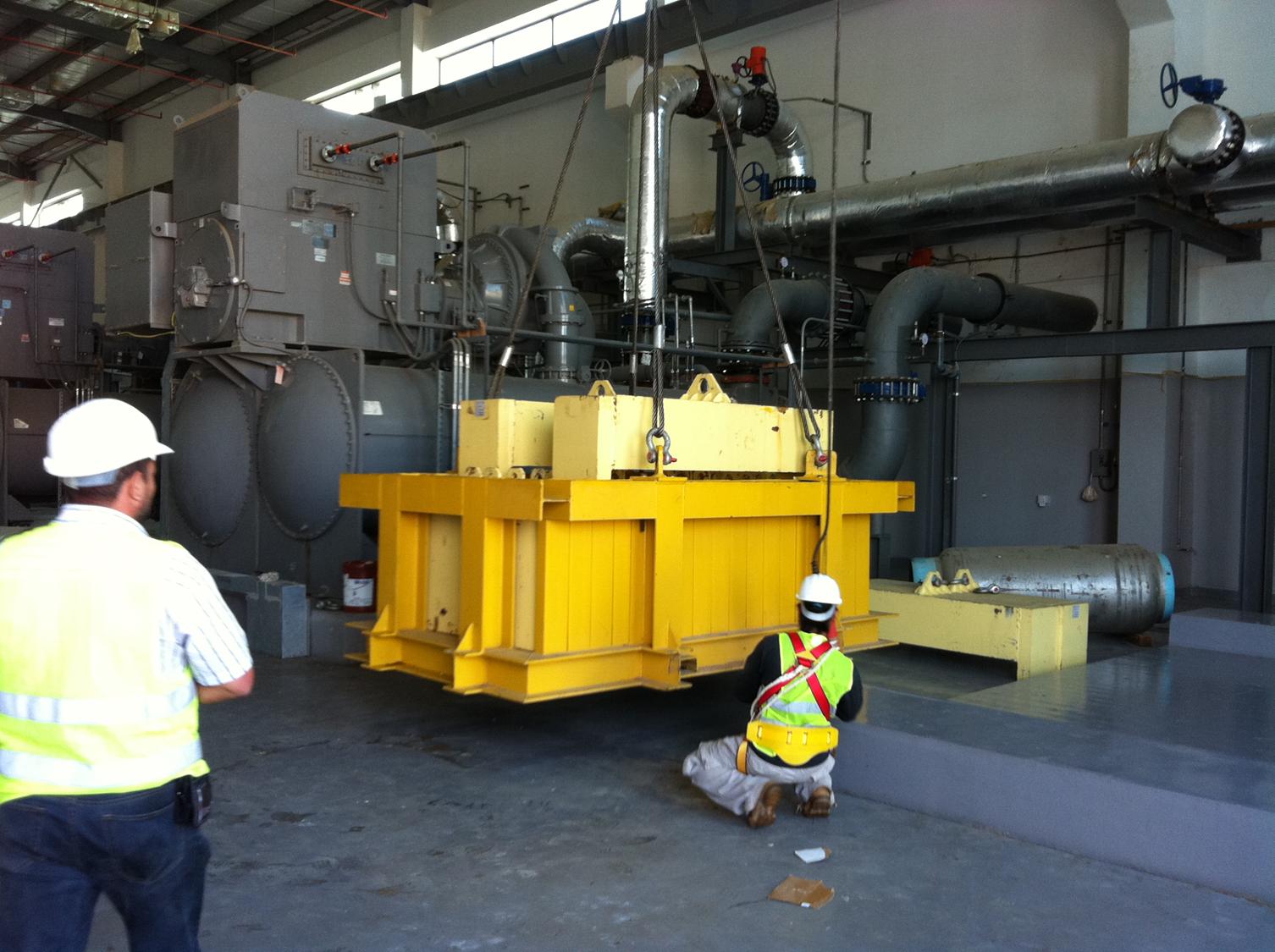 Site crew guiding a lifted steel frame