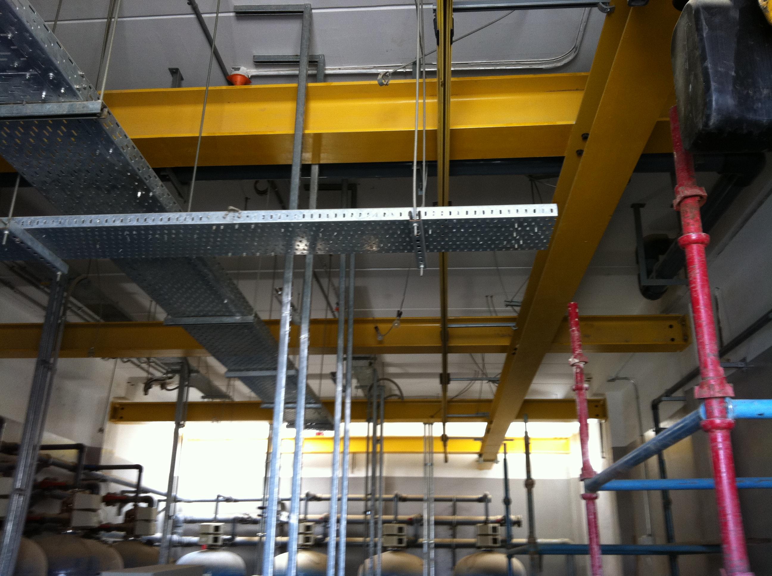 Yellow overhead crane runway inside a plant